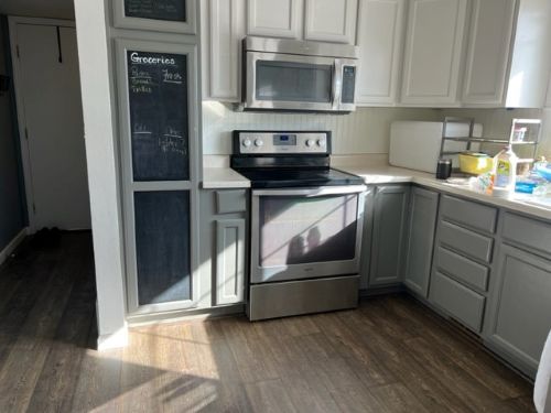 Modern laminate flooring in neutral kitchen with chalkboard.